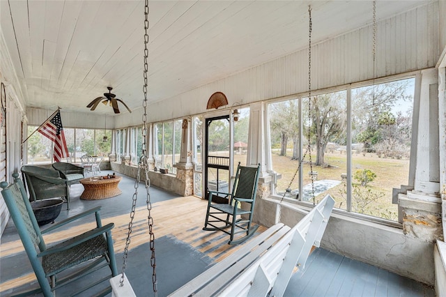 sunroom / solarium featuring ceiling fan and wooden ceiling