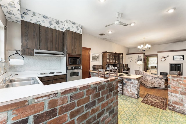 kitchen with black microwave, white cooktop, sink, oven, and dark brown cabinetry