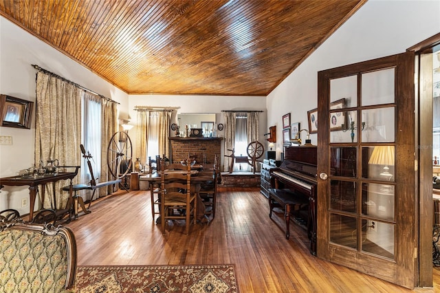 dining area featuring lofted ceiling, wood ceiling, and hardwood / wood-style flooring