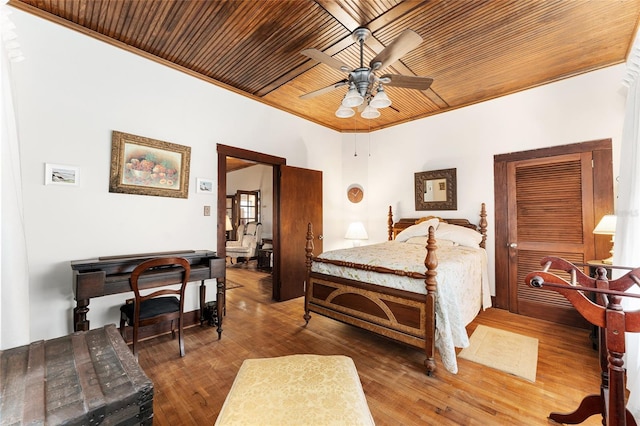 bedroom featuring crown molding, wood ceiling, wood-type flooring, and ceiling fan