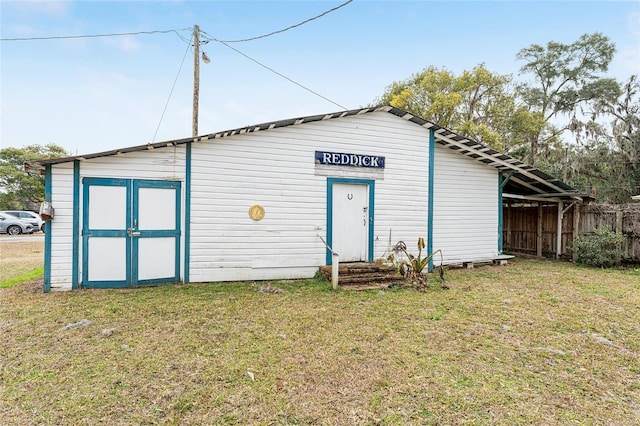 view of outbuilding featuring a lawn