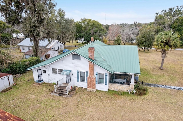 rear view of property featuring a yard