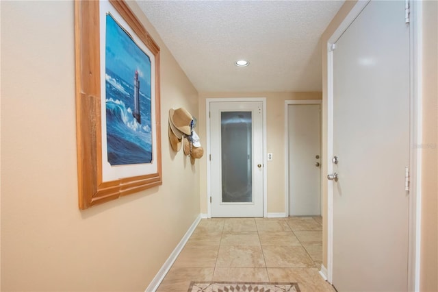 hallway featuring a textured ceiling