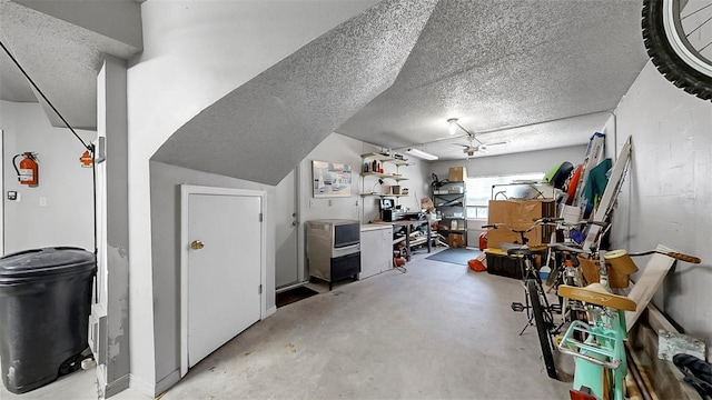 additional living space with concrete flooring and a textured ceiling