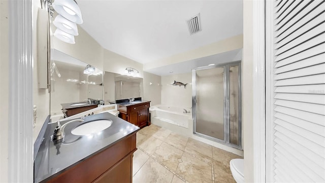 full bath featuring a shower stall, a garden tub, two vanities, and toilet