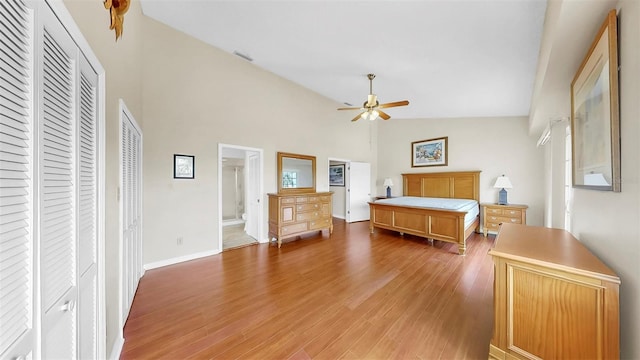 bedroom featuring high vaulted ceiling, light wood-style floors, baseboards, and a ceiling fan