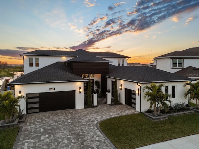 view of front of house with a yard and a garage