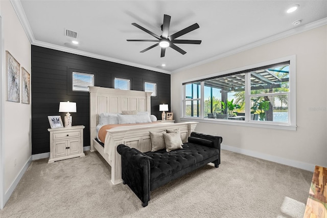 carpeted bedroom featuring ornamental molding and ceiling fan