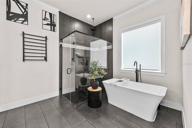 bathroom with ornamental molding and shower with separate bathtub