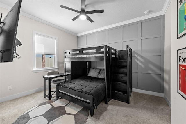 bedroom featuring ornamental molding, light colored carpet, and ceiling fan