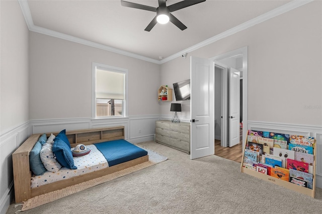 bedroom featuring ceiling fan, light colored carpet, and ornamental molding