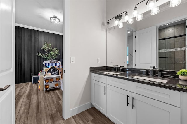 bathroom featuring hardwood / wood-style flooring, ornamental molding, vanity, and an enclosed shower