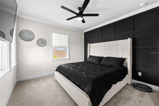 carpeted bedroom with ornamental molding and ceiling fan