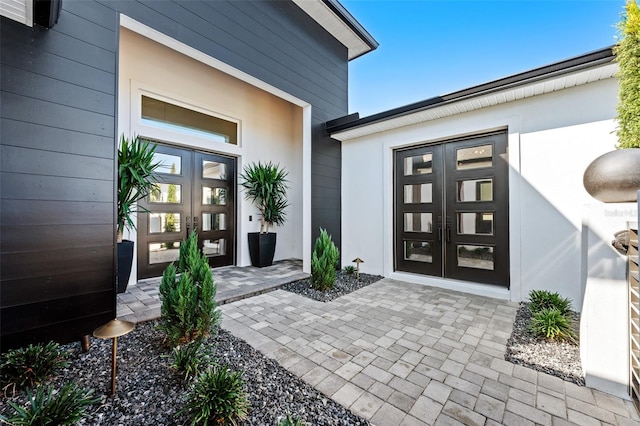 view of exterior entry featuring french doors