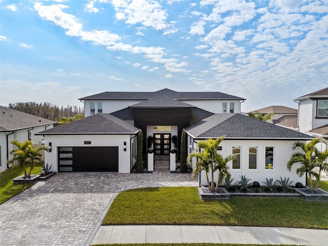 prairie-style house featuring a garage and a front yard