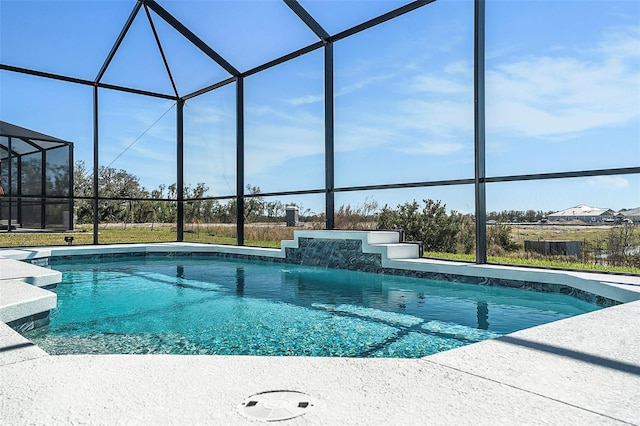 view of pool featuring glass enclosure