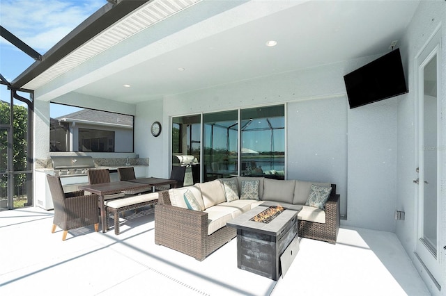 view of patio / terrace featuring outdoor dining space, an outdoor kitchen, an outdoor living space with a fire pit, grilling area, and a lanai