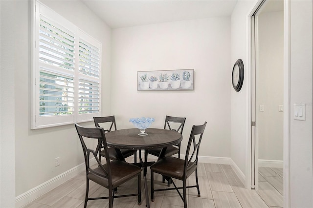 dining space featuring baseboards