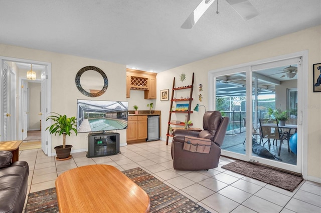 tiled living room featuring bar, wine cooler, and ceiling fan