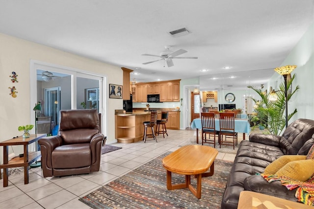 living room featuring ceiling fan and light tile patterned floors