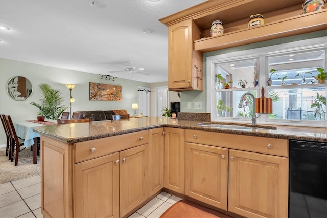 kitchen with sink, dishwasher, light tile patterned flooring, light brown cabinetry, and kitchen peninsula