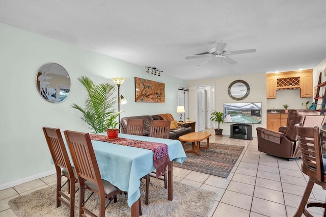 dining room with light tile patterned floors and ceiling fan