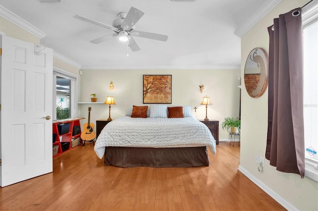 bedroom featuring multiple windows, crown molding, and wood-type flooring