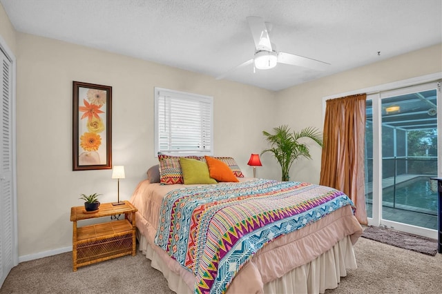 bedroom with ceiling fan, access to outside, light colored carpet, and a textured ceiling