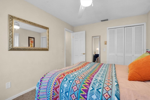 bedroom featuring ceiling fan, a closet, and carpet