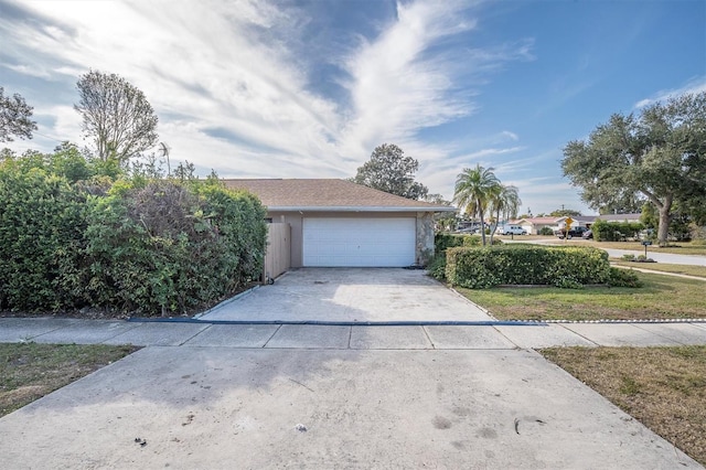 exterior space with a garage and a front lawn