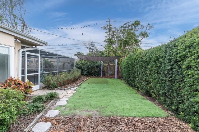 view of yard featuring a lanai