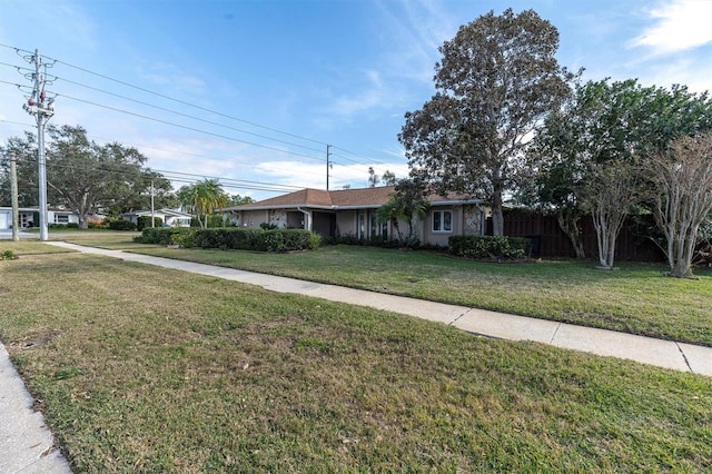 single story home with a front lawn