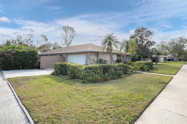 view of side of property featuring a garage and a yard