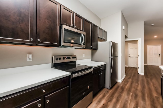 kitchen featuring dark hardwood / wood-style flooring, appliances with stainless steel finishes, and dark brown cabinetry