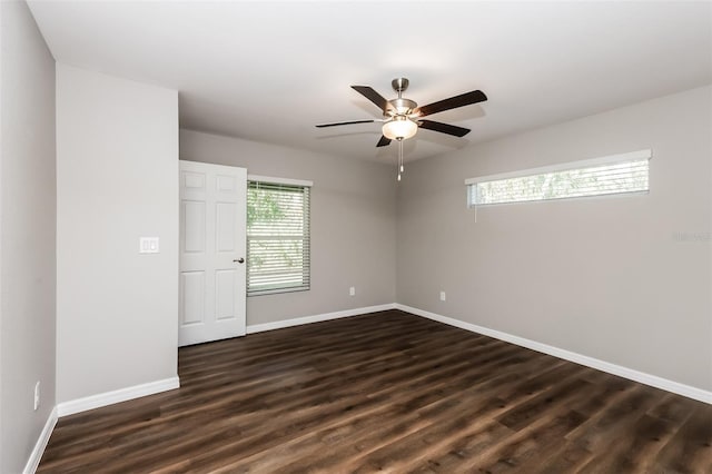 empty room featuring dark hardwood / wood-style flooring and ceiling fan