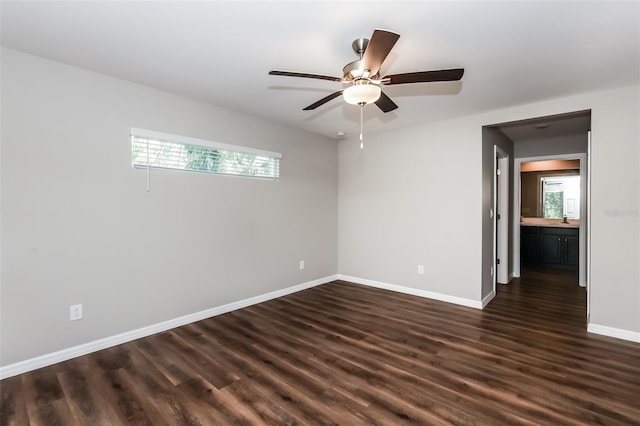 empty room with dark hardwood / wood-style floors and ceiling fan