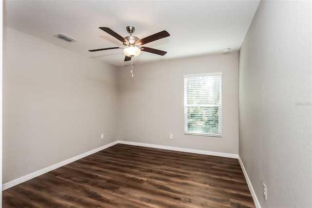 empty room with dark wood-type flooring and ceiling fan