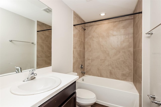 full bathroom with vanity, toilet, and tiled shower / bath combo