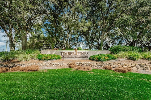 community / neighborhood sign with a lawn