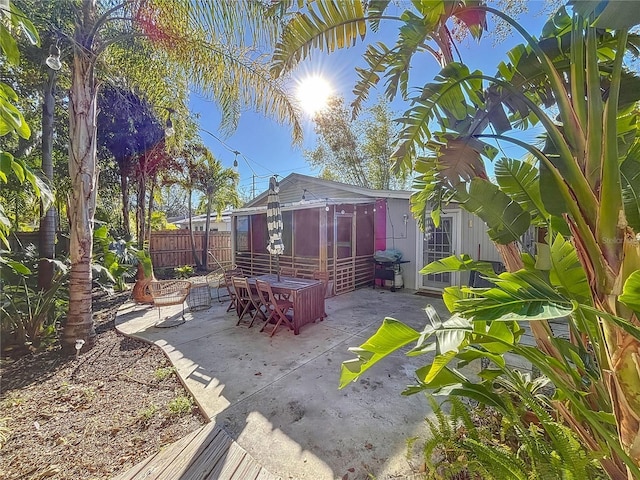 view of patio featuring a sunroom