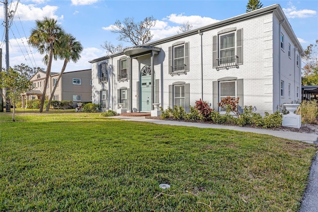 1330 Snell Isle Blvd NE Unit 4, Saint Petersburg, FL 33704 - view of front of house with brick siding and a front lawn