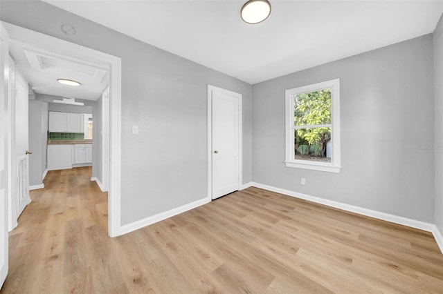 unfurnished bedroom featuring light hardwood / wood-style floors and a closet