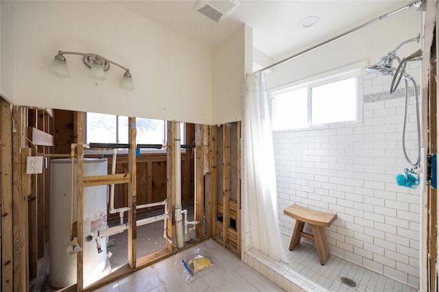 bathroom with gas water heater and curtained shower