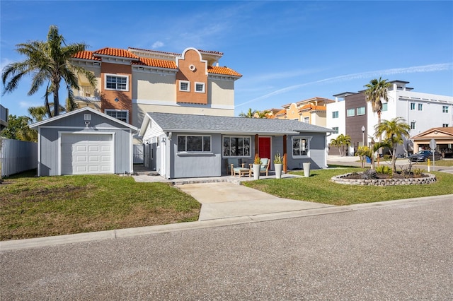 view of front of home with a garage, an outdoor structure, and a front lawn