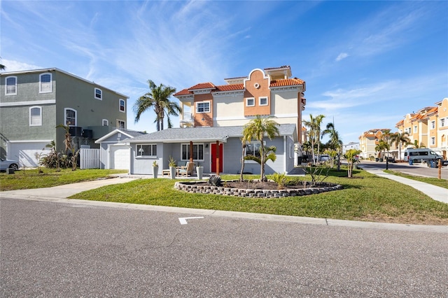 view of front of house featuring a garage and a front yard