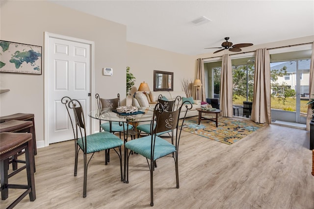 dining area with ceiling fan and light hardwood / wood-style floors