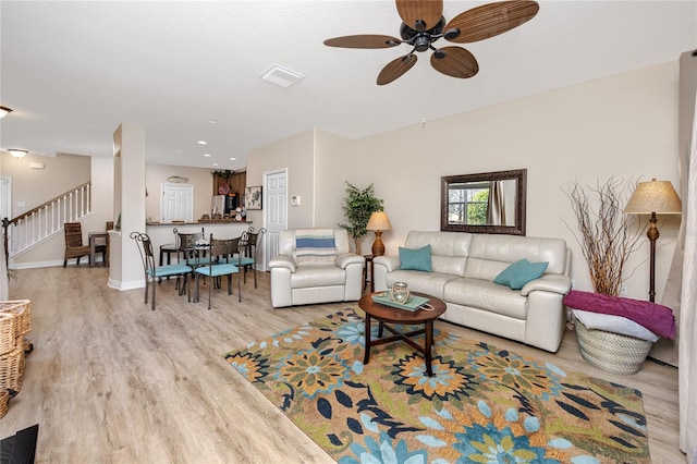 living room featuring light hardwood / wood-style floors and ceiling fan