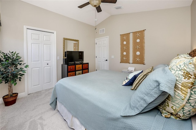 bedroom featuring ceiling fan, a closet, lofted ceiling, and light carpet