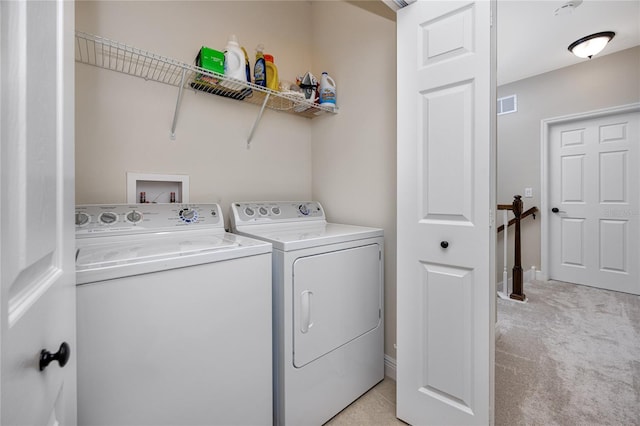 laundry area with light colored carpet and independent washer and dryer