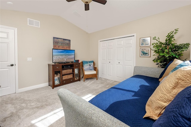 carpeted living room featuring vaulted ceiling and ceiling fan